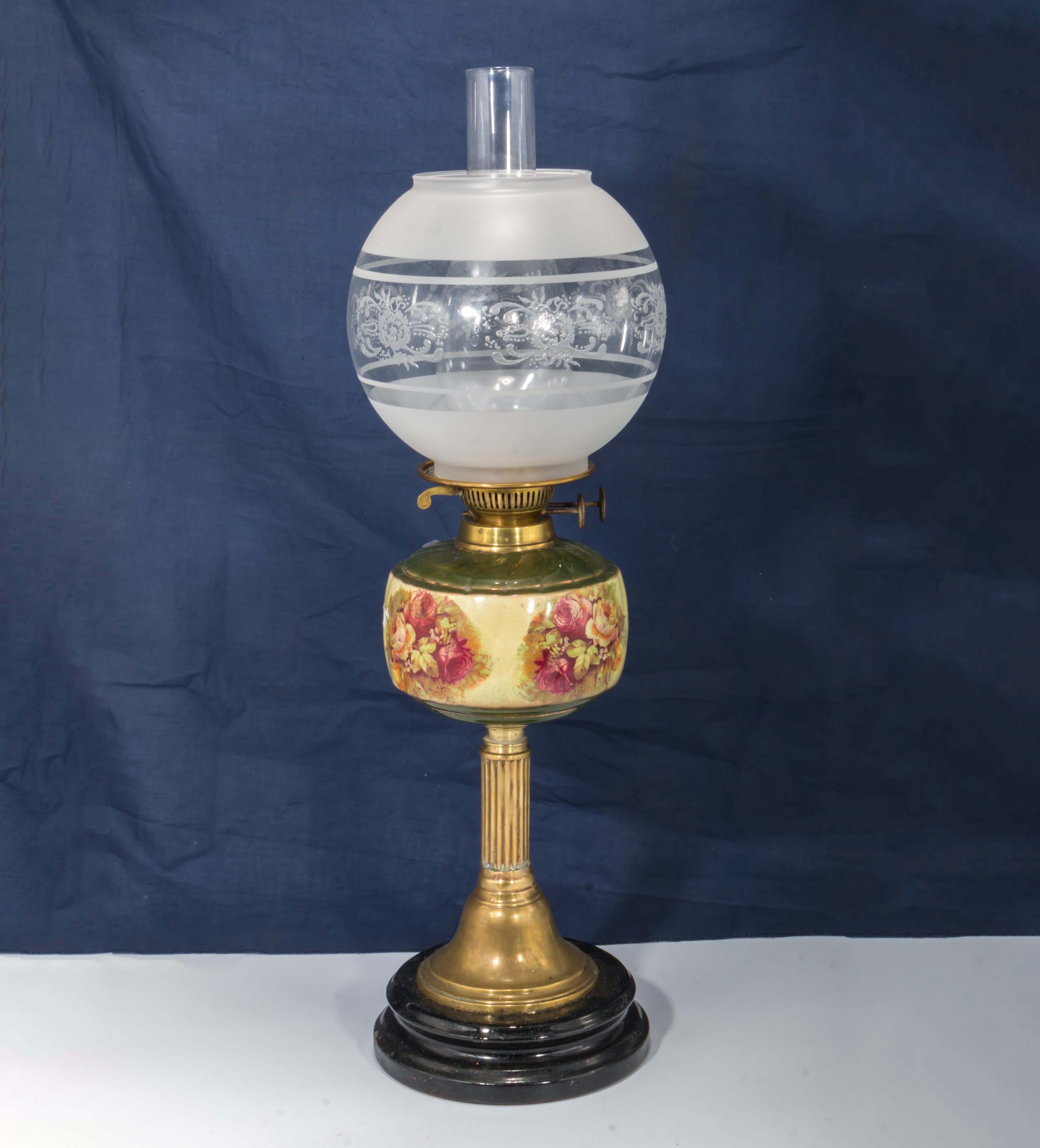 A brass and porcelain oil lamp