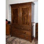 A good quality mahogany two door press with two over two drawers, possibly Maples