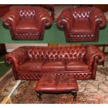 A four piece Chesterfield suite in red leather.