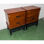 A pair of hard wood bedside cabinets
