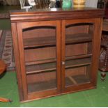 A mahogany bookcase top