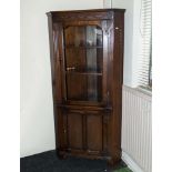 A 20th century oak corner cupboard
