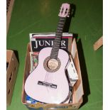 A child's guitar and books