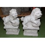 A pair of reconstituted stone garden lions