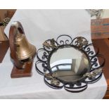 A brass bell together with a mirror