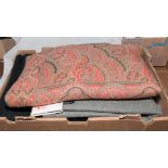 A box containing a Paisley shawl and tweed material