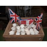 A box of commemorative china mugs