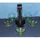 A decanter and five green sundae glasses