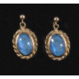 A pair of 9ct gold earrings set with blue opals