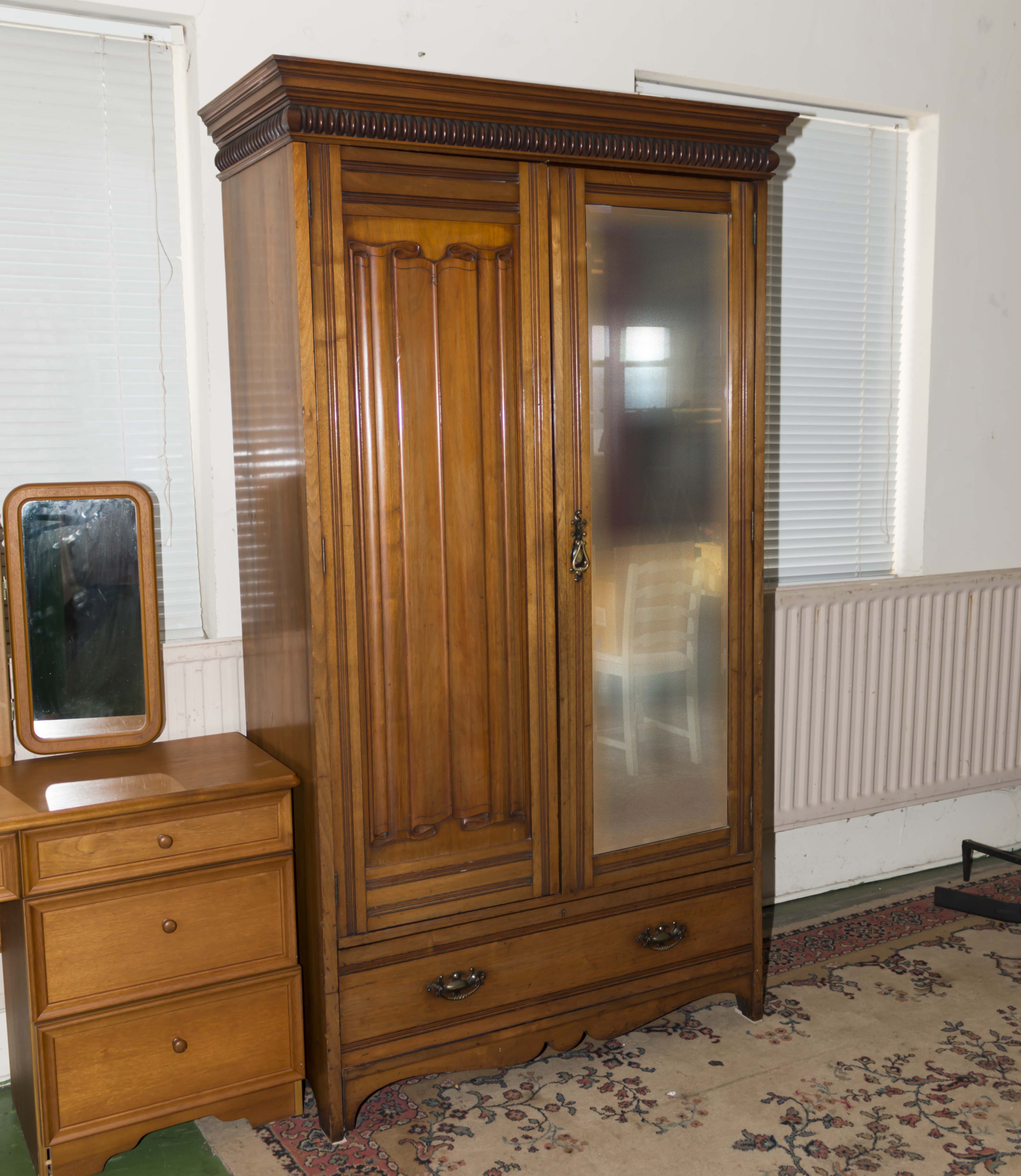 A mahogany two door wardrobe