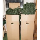Two boxes containing two large half artificial Christmas trees