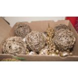 A box containing gold coloured Christmas decorations