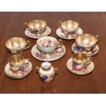 A collection of Aynsley 'Orchard Gold' pattern teacups and saucers