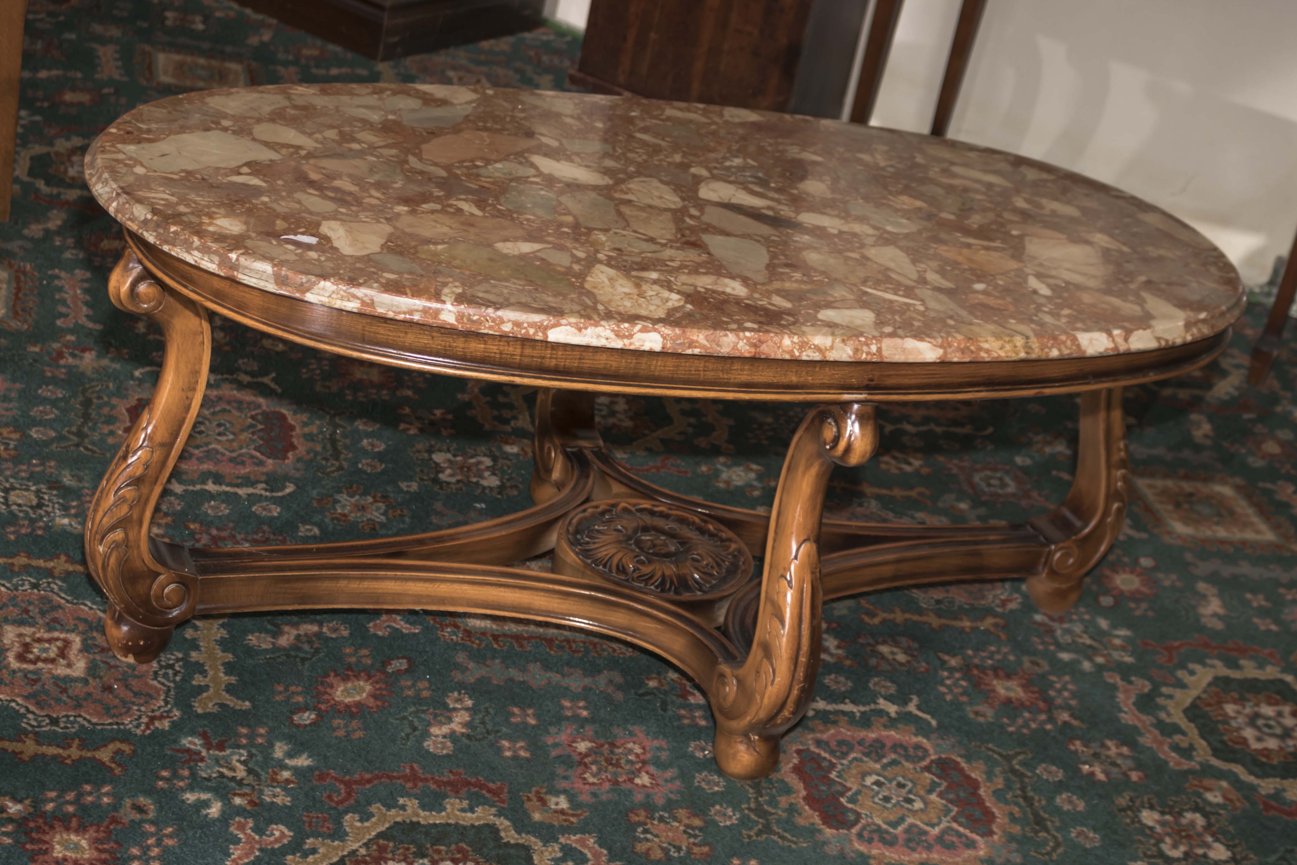 A walnut based marble topped coffee table