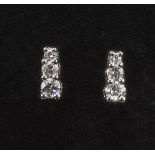 A pair of 9ct white gold diamond earrings, 35pt.