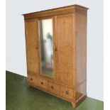 A Satinwood two door wardrobe with centre mirror and two drawers