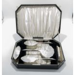 A cased silver dressing table set, marks for Birmingham 1932, makers mark D M Co.