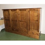 A pine low wardrobe with drawers