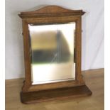 An oak framed toilet mirror