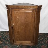 An oak corner cupboard