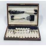 A cased set of fish cutlery and servers