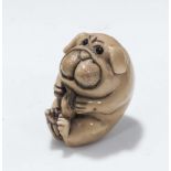 Tagua nut style netsuke of a dog