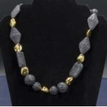 Unique designer gilt, lava rock necklace
