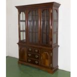 A reproduction bookcase on cupboards