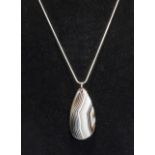 A polished banded agate slice on Sterling silver chain