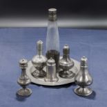 Assorted old Pewter condiments on plate