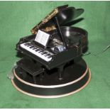 A Christmas decoration designed as a grand piano with Christmas music discs
