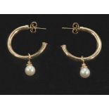 A pair of 9ct gold half hoop earrings with pearls