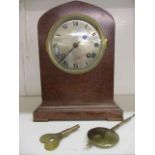 An early 20th burr maple cased mantle clock with a key