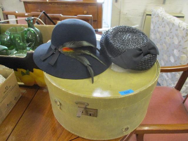 A vintage hat box, together with two vintage ladies hats