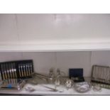 Two silver plated sugar sifters and mixed silver plated table ware, together with a silver napkin