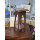 A Middle Eastern carved hardwood, two tier occasional table with central mother of pearl