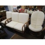 A cane two seater settee, together with a matching armchair and a similar swivel chair