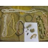 A mixed selection of vintage necklaces to include a carved bone necklace, together with an Edwardian