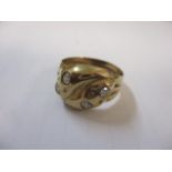 A 9ct gold ring with four inset diamonds fashioned as a snake
