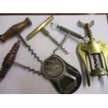 A selection of vintage corkscrews and a bottle opener