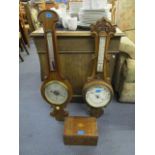 A Victorian walnut cased wheel barometer with turned ivory adjustable button, a later carved oak