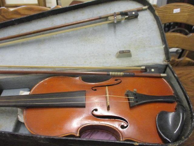 An early 20th century cased violin and two bows, label to inside of violin reading 'copy of Joset