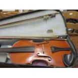 An early 20th century cased violin and two bows, label to inside of violin reading 'copy of Joset