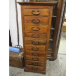 A modern teak bank of ten drawers having wrought iron handles,, 57 1/4" h x 22"w