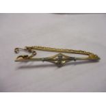 A yellow and white metal three stone diamond bar brooch, stamped 18ct