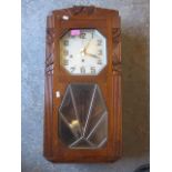 An Art Deco oak cased, eight day wall clock, 27" x 13"