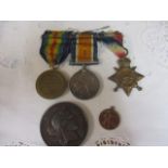 A trio of WW1 medals, a French medallion and a Transvaal war commemorative pendant