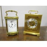 A brass cased five window carriage clock with serpentine facade, white enamel dial, on four turned