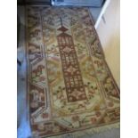 A Middle Eastern brown and beige ground rug, 80" x 43"