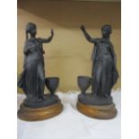 A pair of 20th century spelter figures in the form of female Grecian dancers, mounted on oak plinths